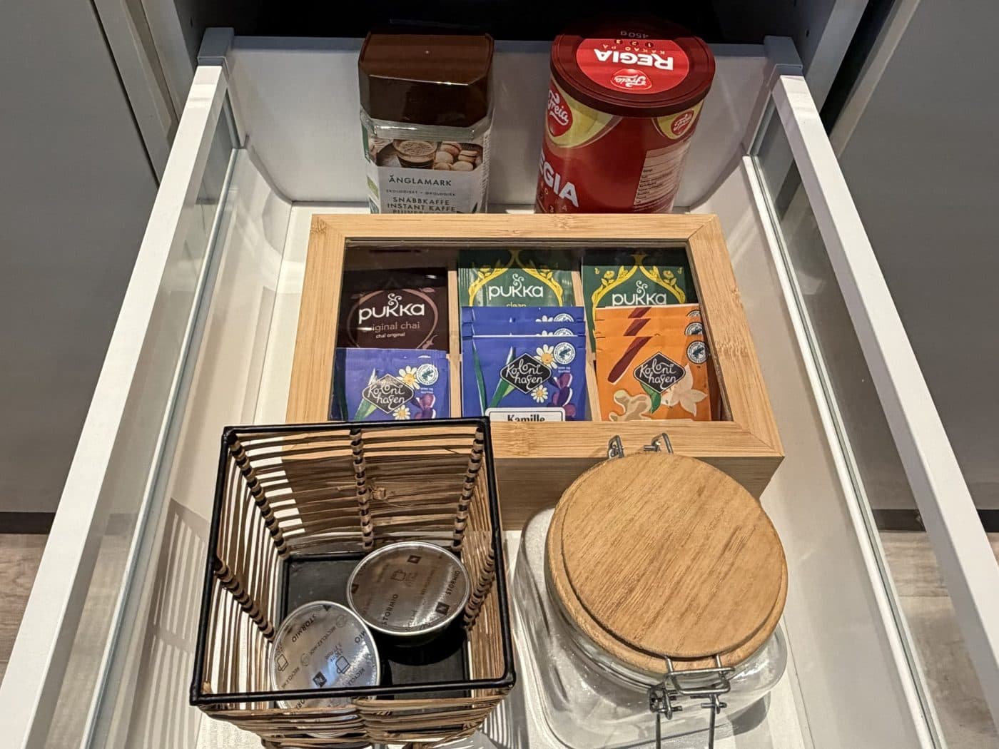The drawer with capsules, tea, sugar, instant coffee and hot chocolate
