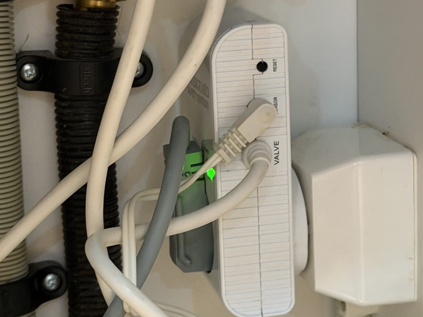 Close-up of the water guard with the grey plug and green light