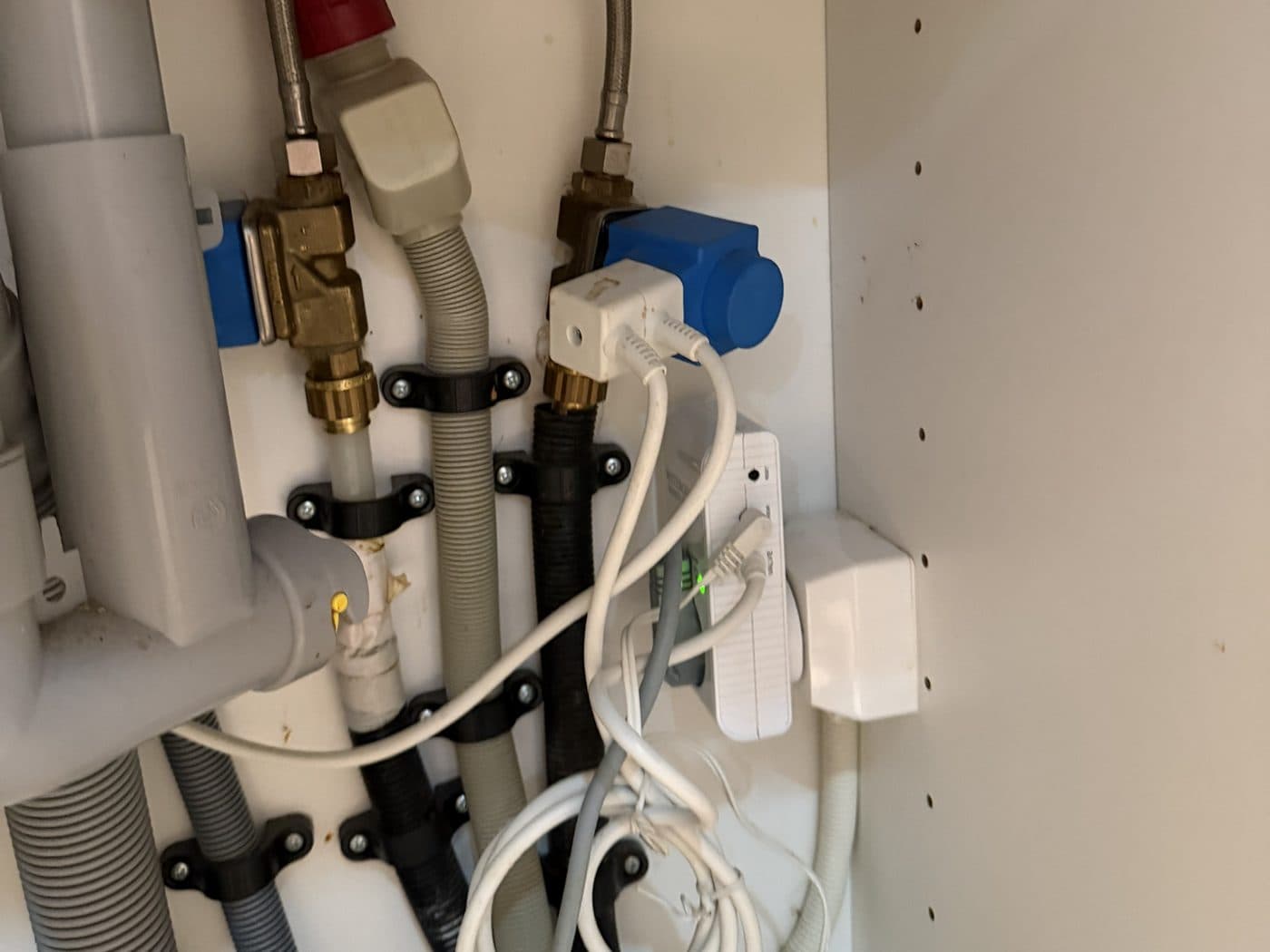 Under the sink with the bins removed: the white water guard box with a green light