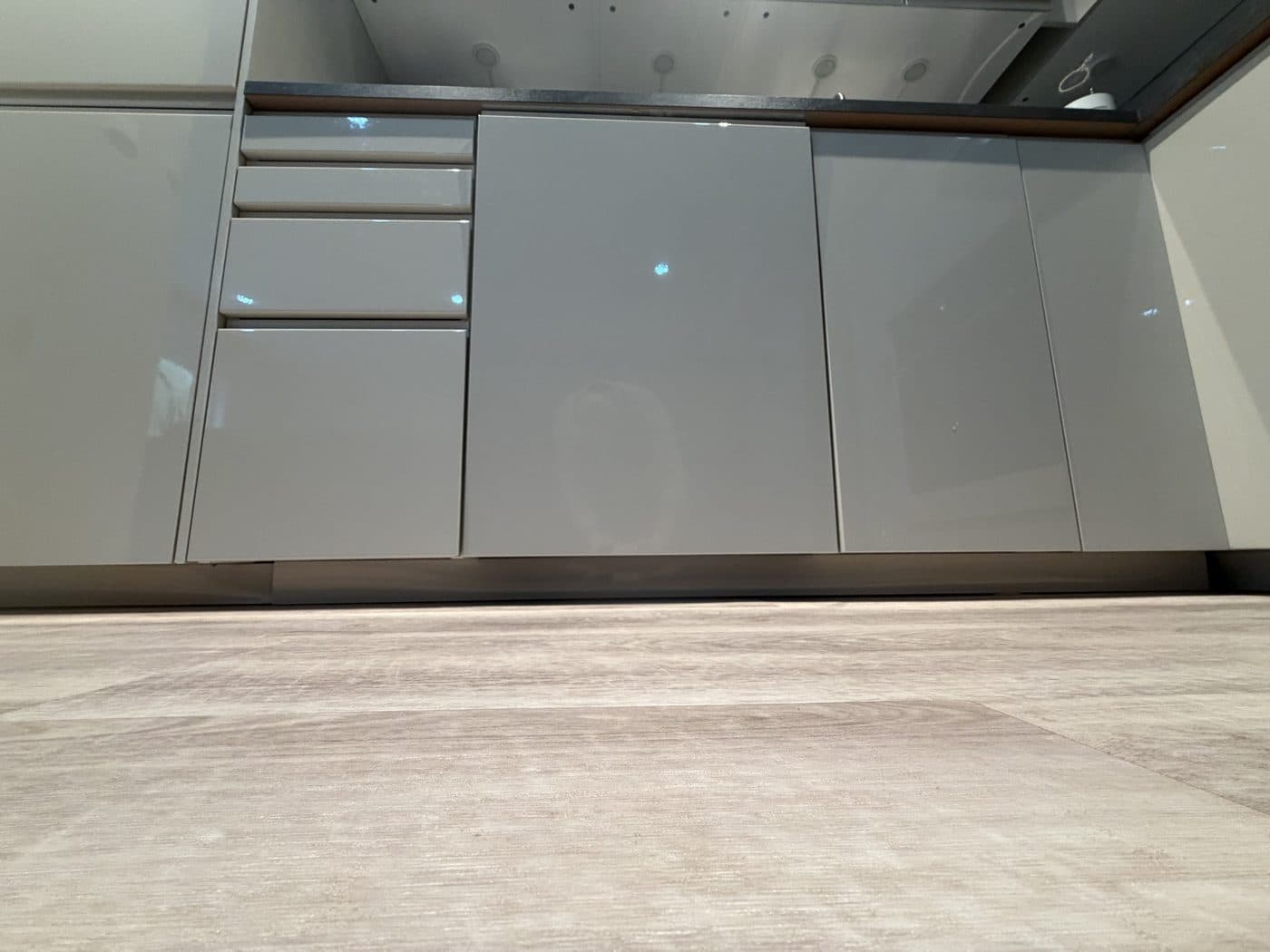 The dishwasher: the middle door, right of the drawers